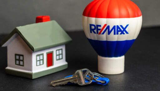 a remax hot air balloon beside a small home and a set of keys