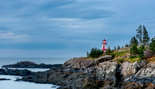 View of the Head Harbour Lightstation on rocky cliffs in New Brunswick, Canada.