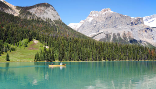 People in a canoe on Emerald Lake, Banff, Alberta, Canada.