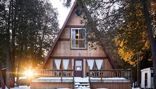 outside shot of A-frame cottage in the snow