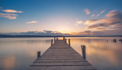 A long wooden dock at sunset