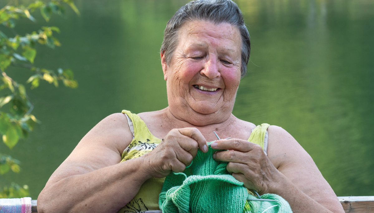 Christina Jones knits near the lake.
