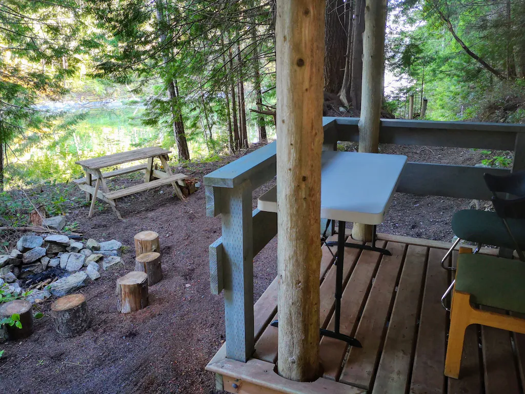 Small deck overlooking campfire and picnic table
