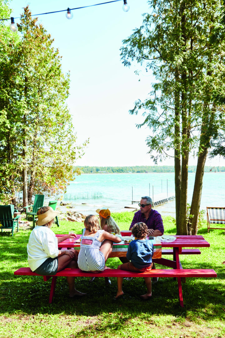 Heather Rice and her family eating on a picnic table outside the cottage
