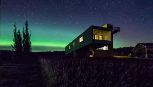 Northern lights light up the sky and container cabin
