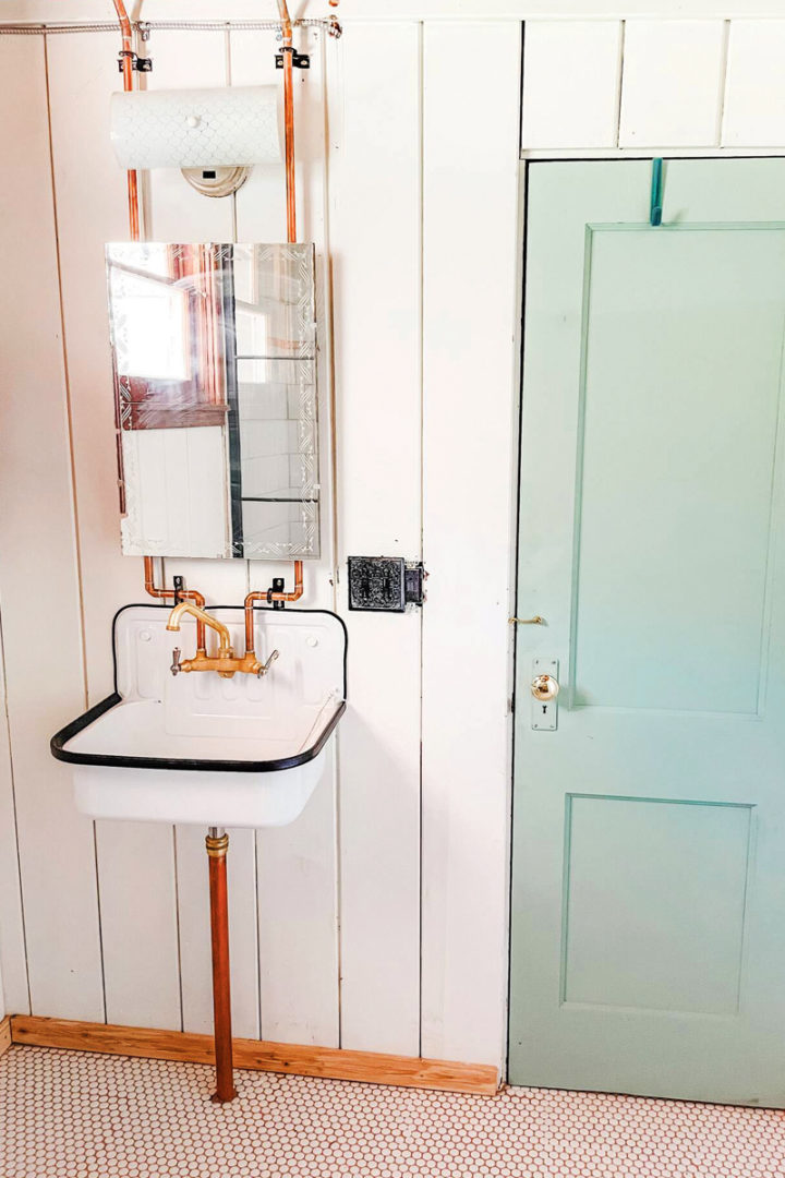 the renovated bathroom with exposed copper piping