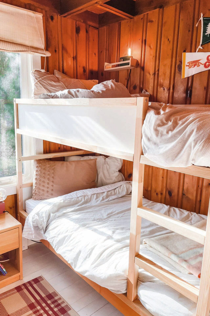 a bunkbed in a plywood-panelled wall bedroom