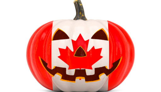 A carved pumpkin painted with the Canadian flag