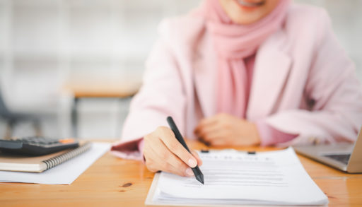 muslim business woman with contract agreement document. halal mortgages