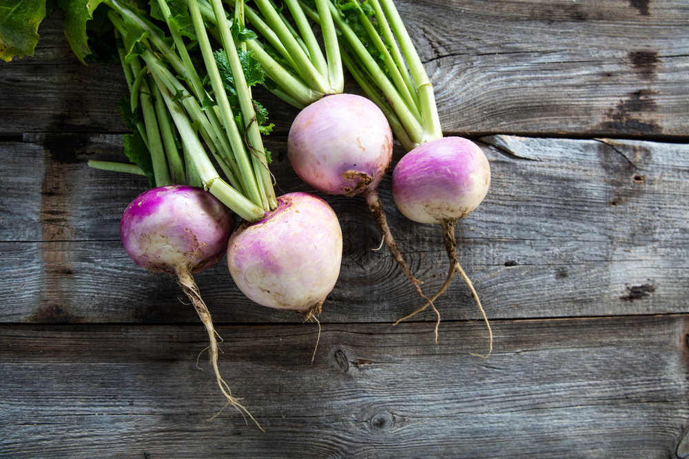 A cluster of turnips against a wood background