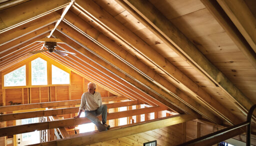 Albert Crowder sitting in the rafters of his cottage
