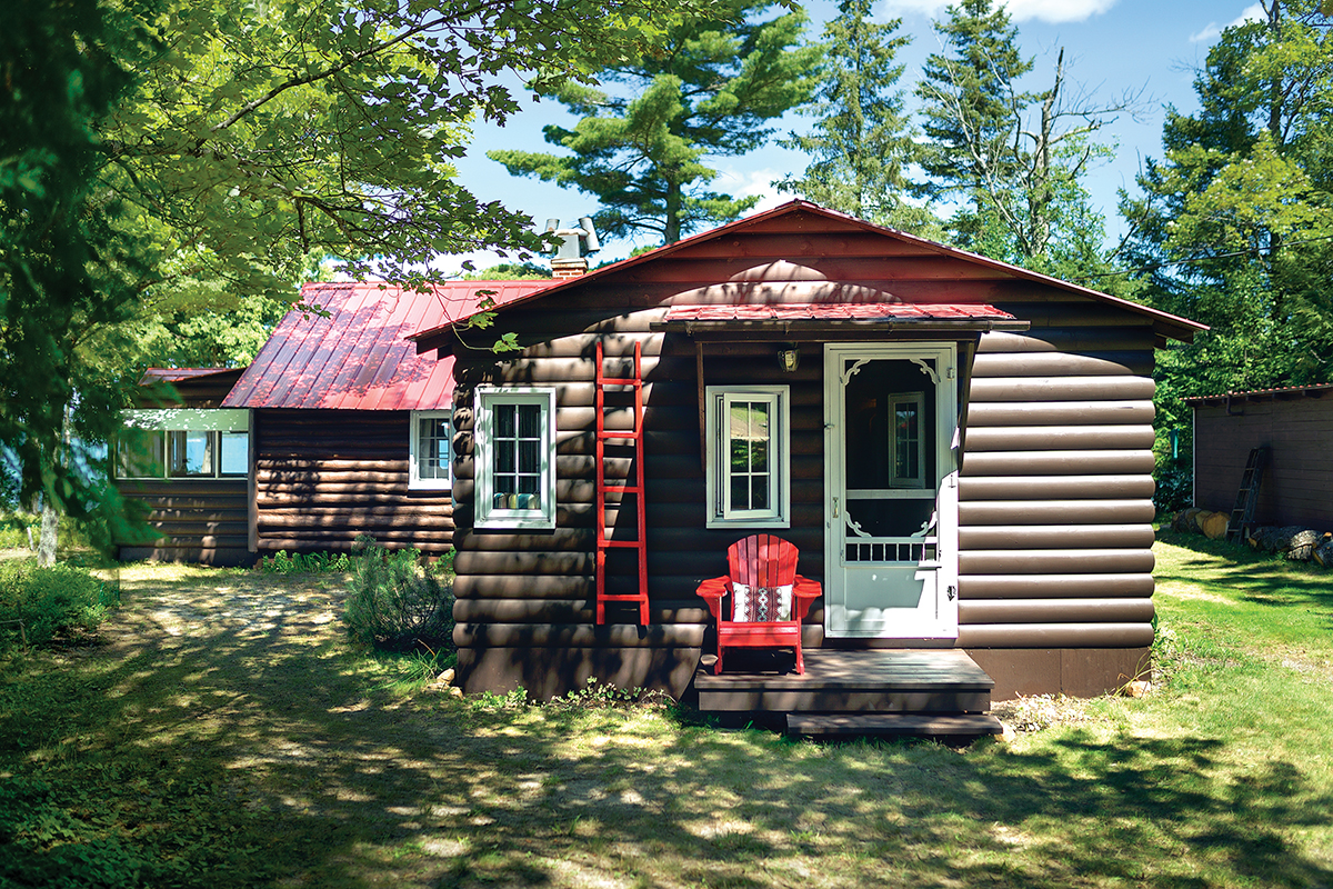 cottage addition from the outside with red roof and brown log siding