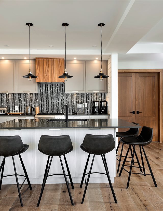kitchen from behind the island with black stools