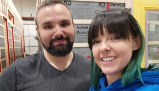 Photo of the couple in the warehouse where their tiny home was being built