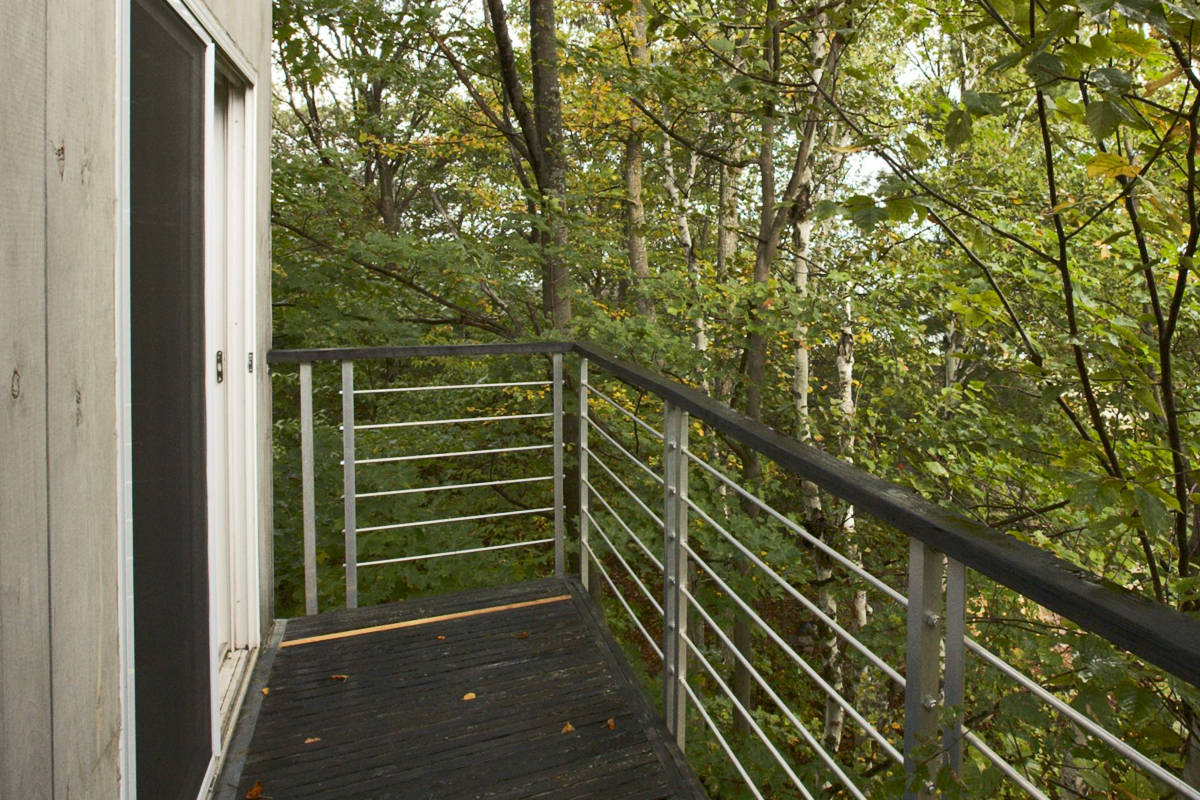 A cable-type railing surrounding a deck