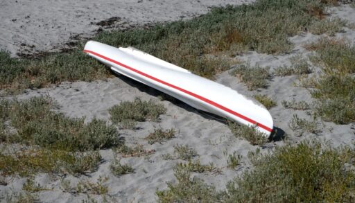 Overturned kayak on the shore of a beach