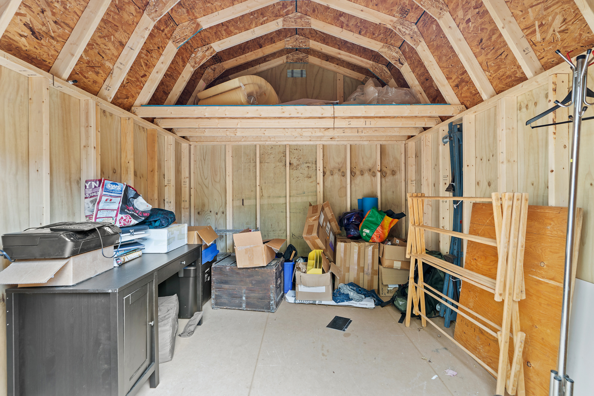 Interior of a small shed with lots of storage space.