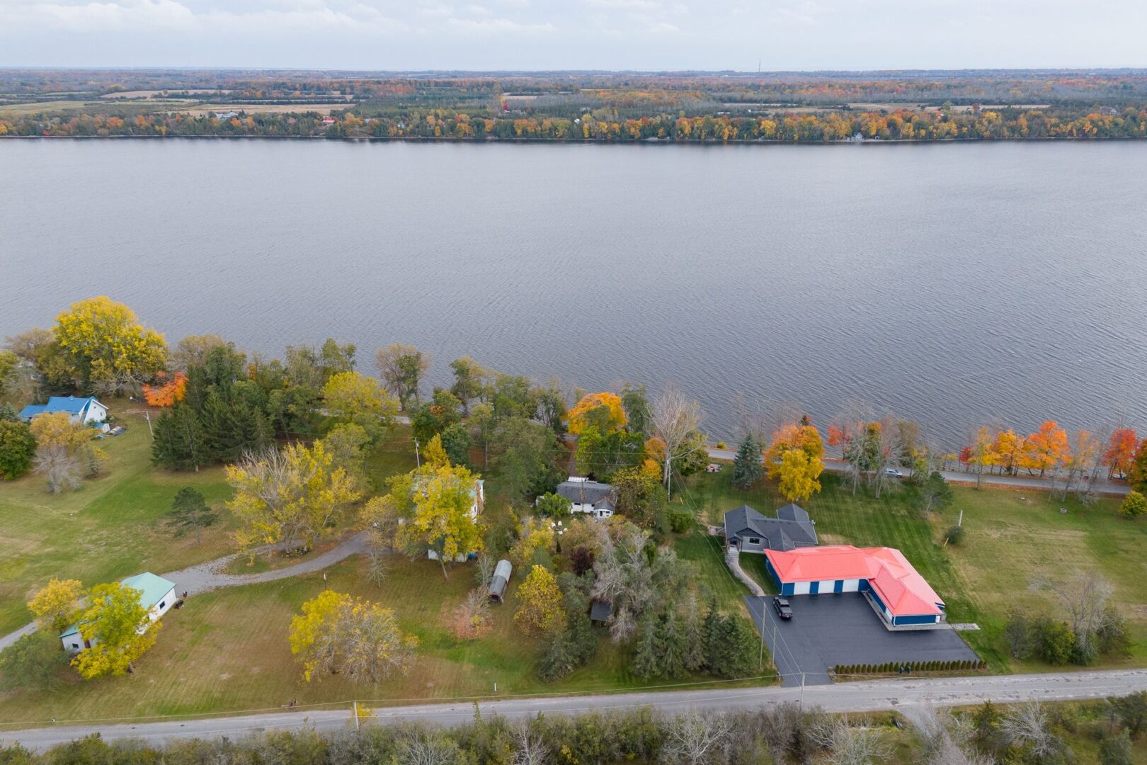 Overhead view of a stretch of lake, with a few houses lining the waterfront.