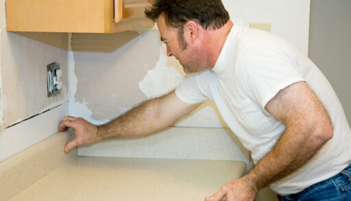 A man installing a laminate countertop
