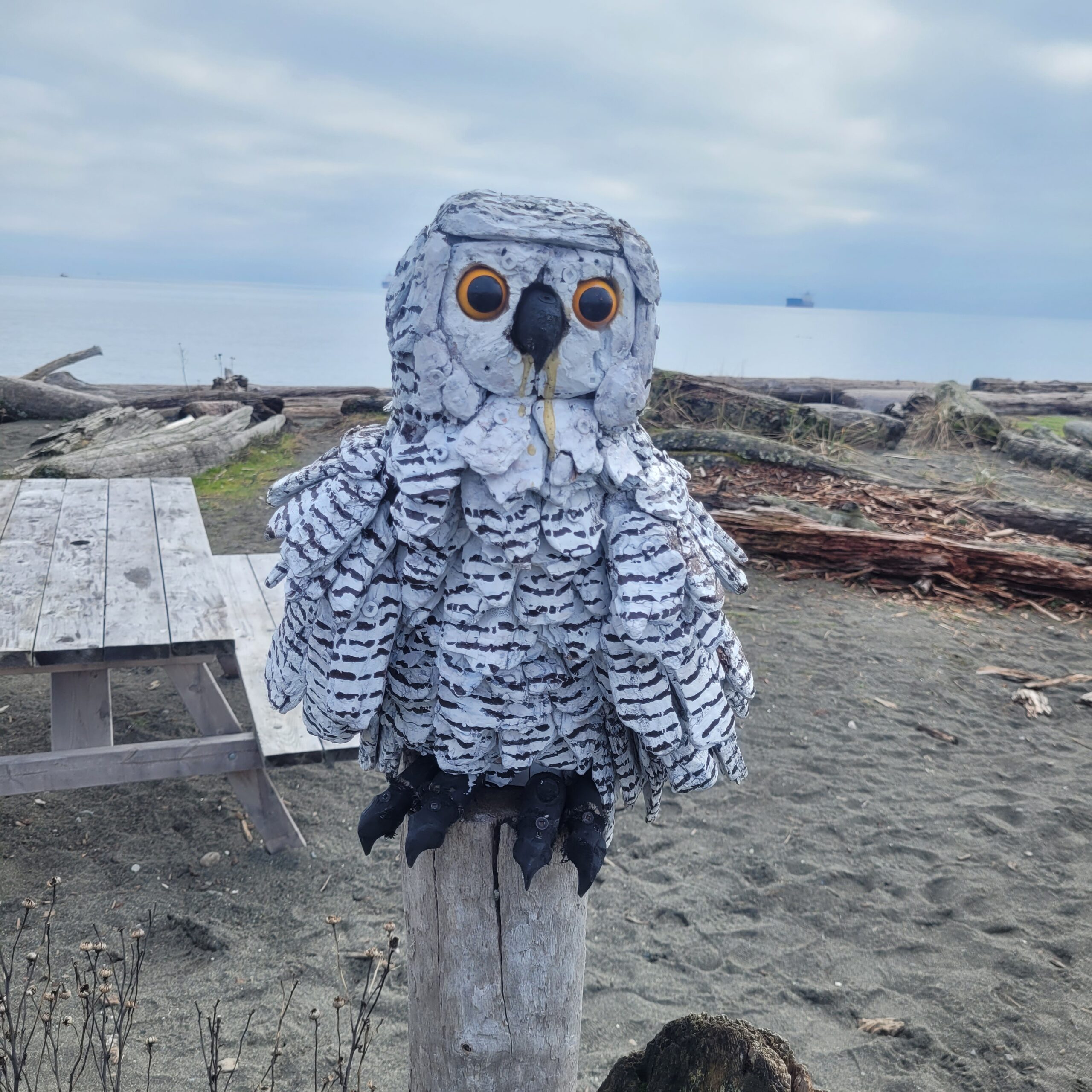 a driftwood sculpture of an owl